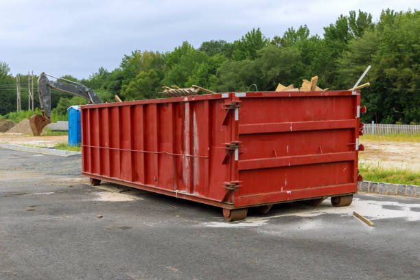 home renovation maintenance a loaded dumpster near a construction site